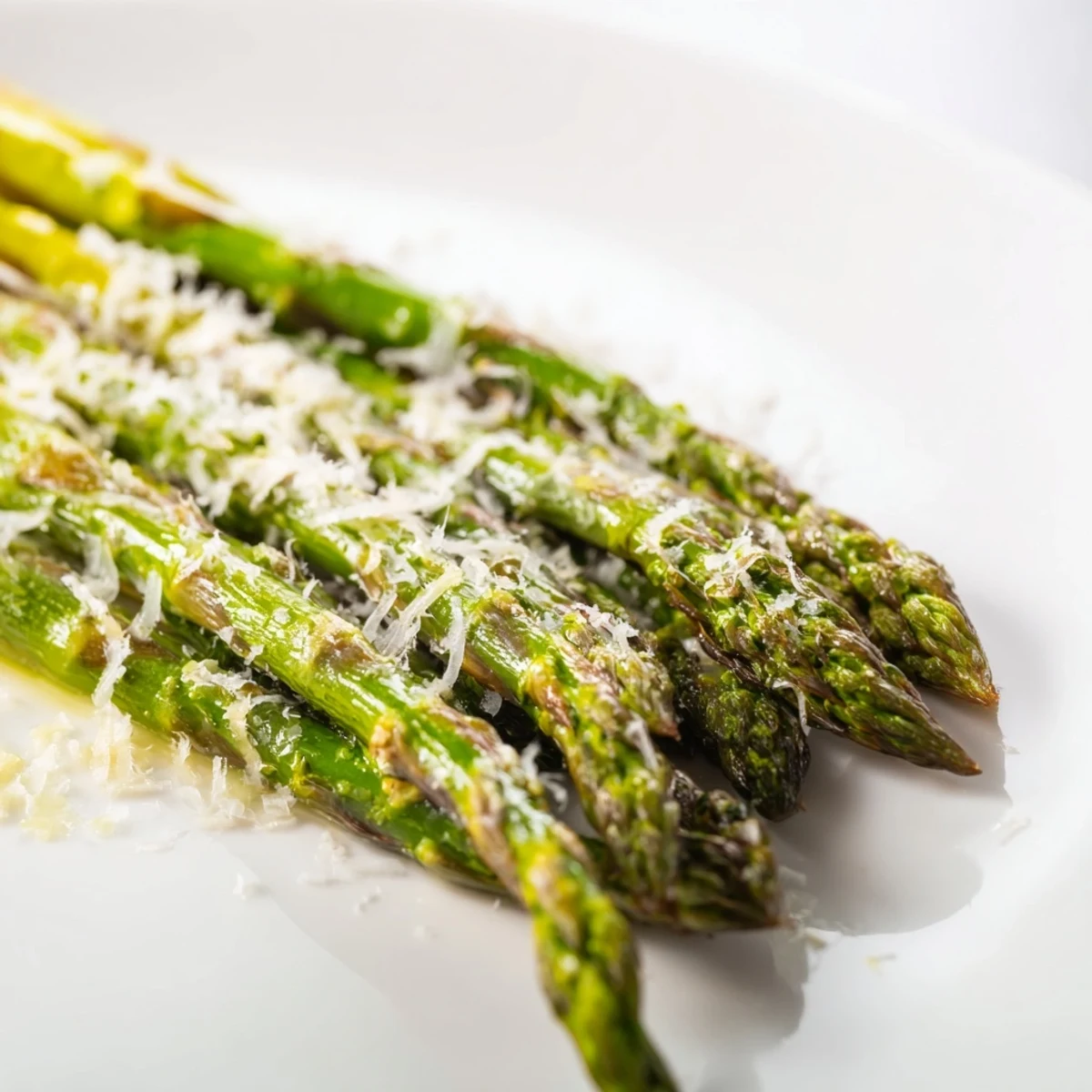 Crisp roasted asparagus with Parmesan and lemon, ready to serve alongside grilled chicken or fish for dinner.