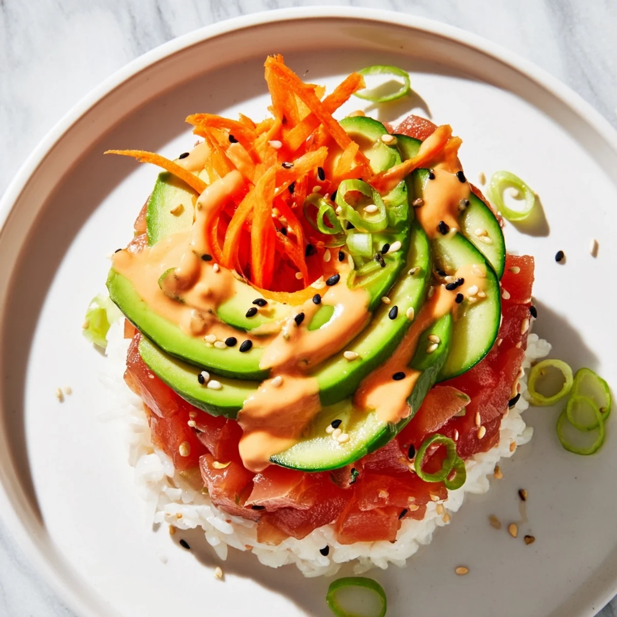 Fresh Spicy Tuna Poke Bowl with diced tuna, avocado, cucumber, and edamame, arranged beautifully on warm seasoned sushi rice.