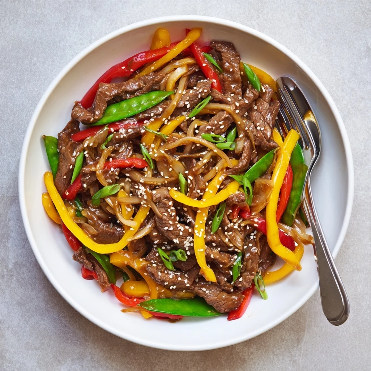 Vibrant, glossy sauce coating tender beef and colorful vegetables for a quick, dairy-free dinner.