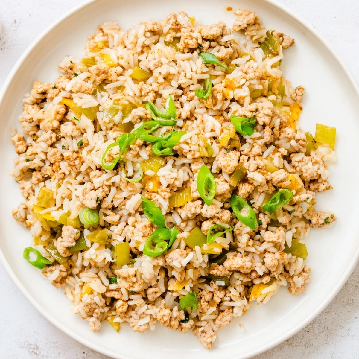 This hearty Cajun Dirty Rice with Ground Turkey showcases a savory blend of spices and tender protein in a rustic skillet.