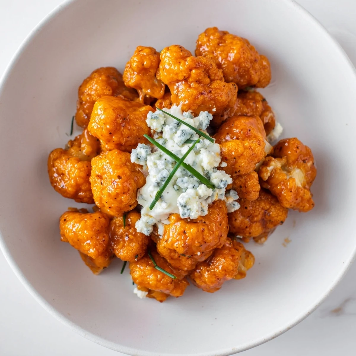Close-up of Buffalo Cauliflower Wings served with creamy blue cheese dip, highlighting the spicy, vegetarian-friendly appetizer texture.