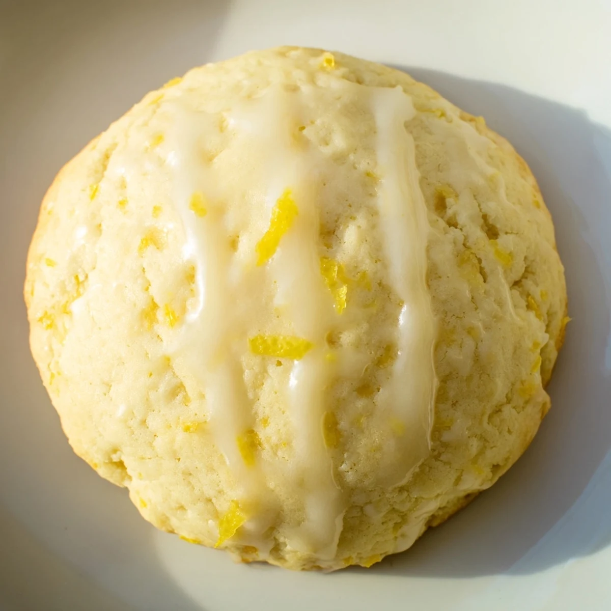Homemade Lemon Ricotta Cookies with a tender crumb and zesty glaze, stacked on a white ceramic plate.