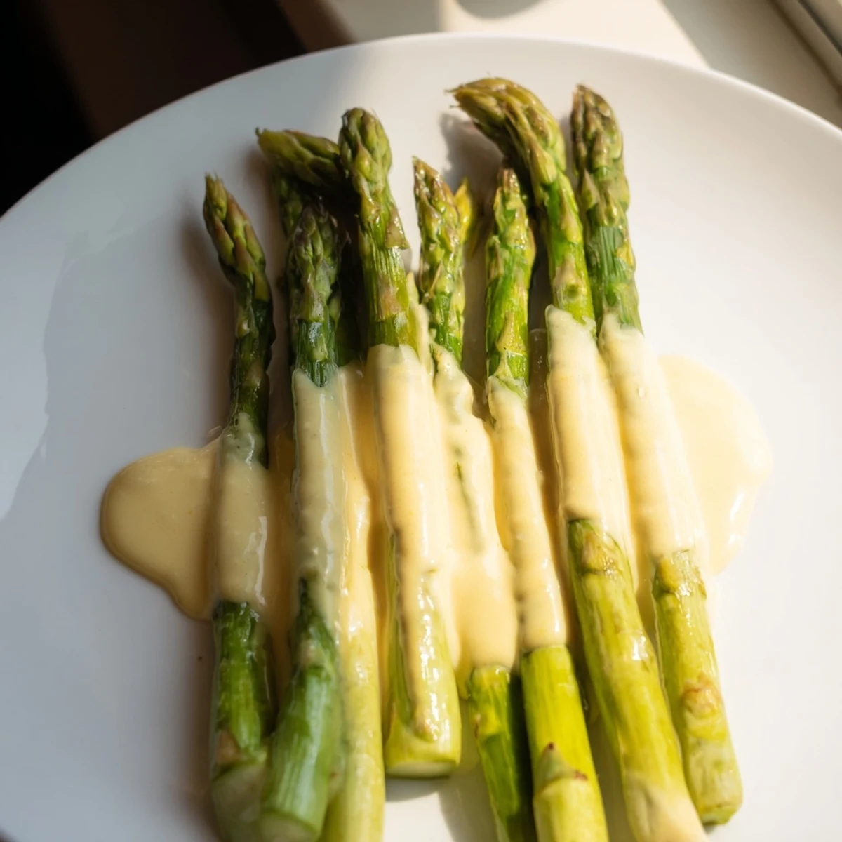 Tender roasted asparagus with hollandaise sauce drizzled over the golden, crisp spears.