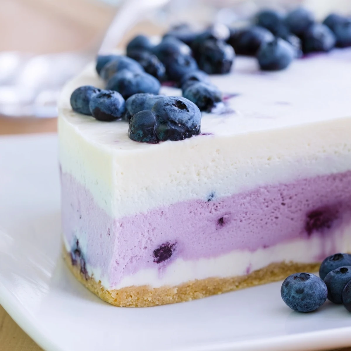 This homemade Blueberry Mousse Cheesecake showcases a luscious texture and vibrant purple hue, perfect for summer entertaining.