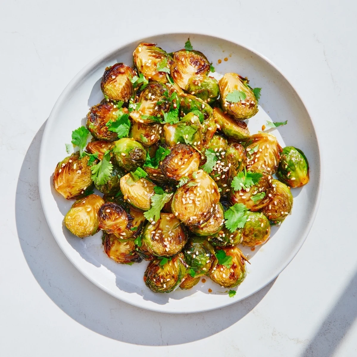 Crispy Honey Sriracha Brussels Sprouts served warm as an appetizer with a sweet and spicy glaze.