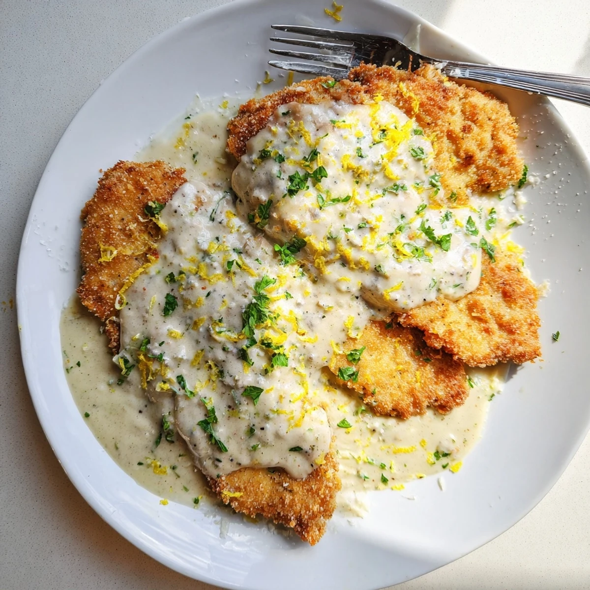 Served over pasta, the Creamy Parmesan Lemon Chicken glistens with a rich, lemony sauce and melted cheese.