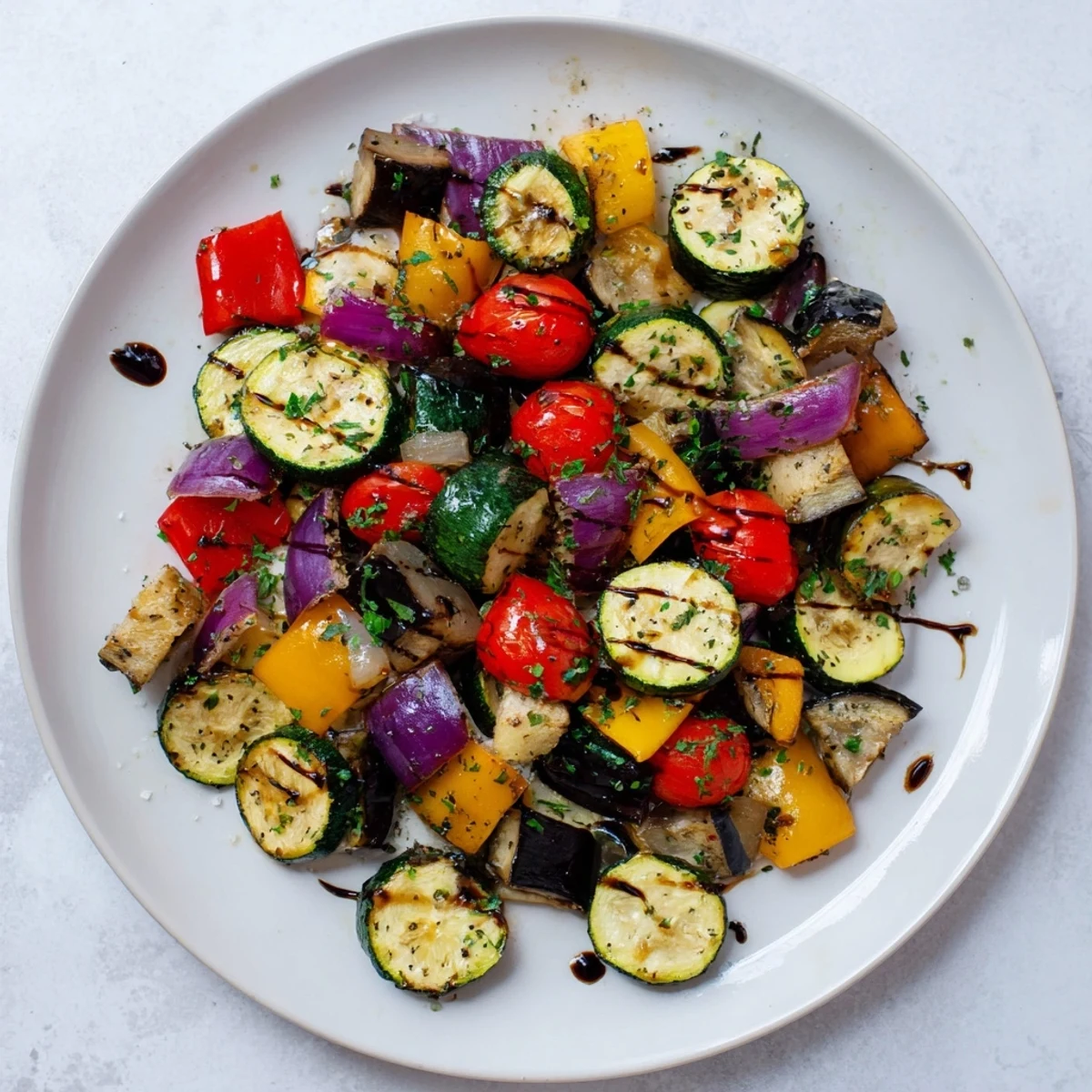 Italian Roasted Vegetables served warm from the oven, with balsamic glaze drizzled over tender, caramelized veggies.
