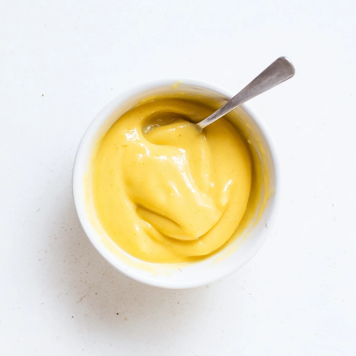Luscious bright yellow easy vegan mango curd spread generously on whole grain toast