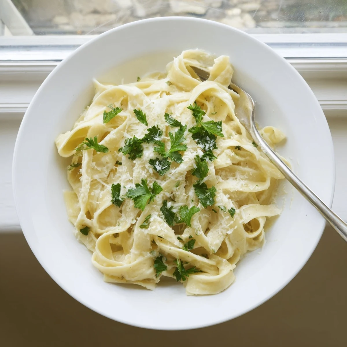 Creamy fettuccine Alfredo pasta tossed in rich Parmesan butter sauce with fresh parsley garnish