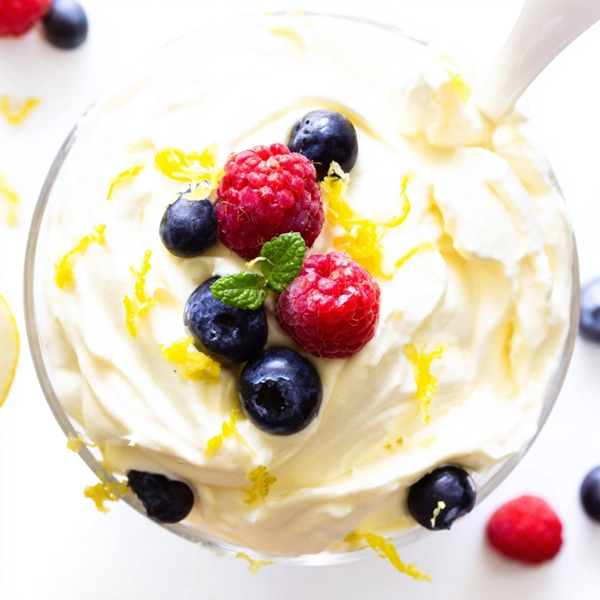 Silky smooth no bake lemon mascarpone mousse served chilled with whipped cream and fresh lemon twists