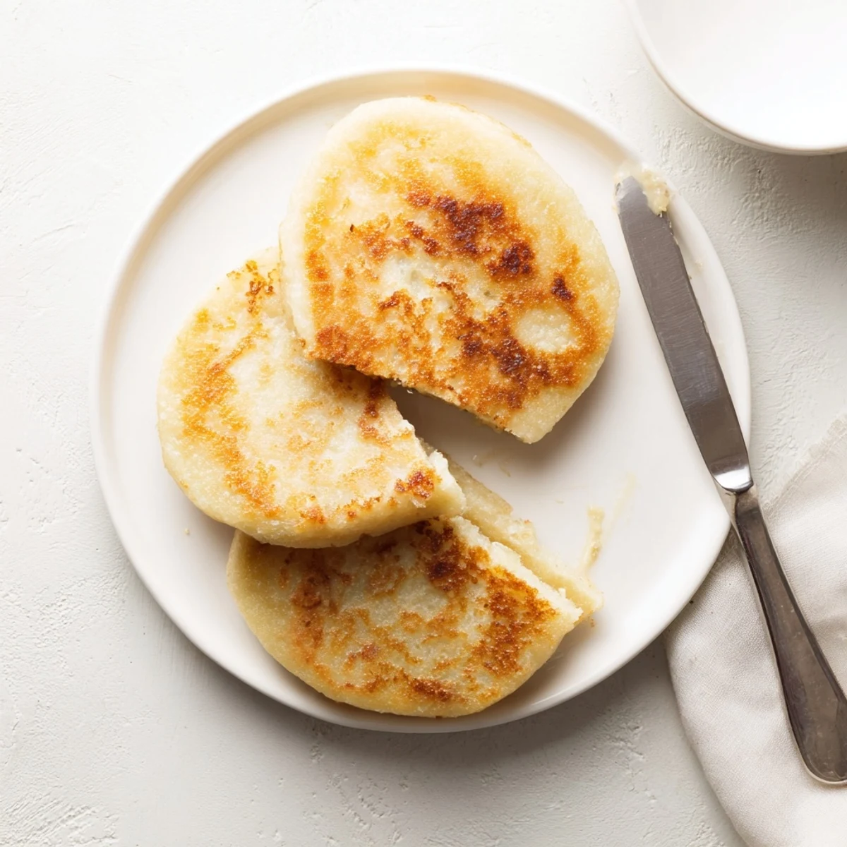 Golden brown Irish potato cakes sizzling in a buttered skillet with crispy edges
