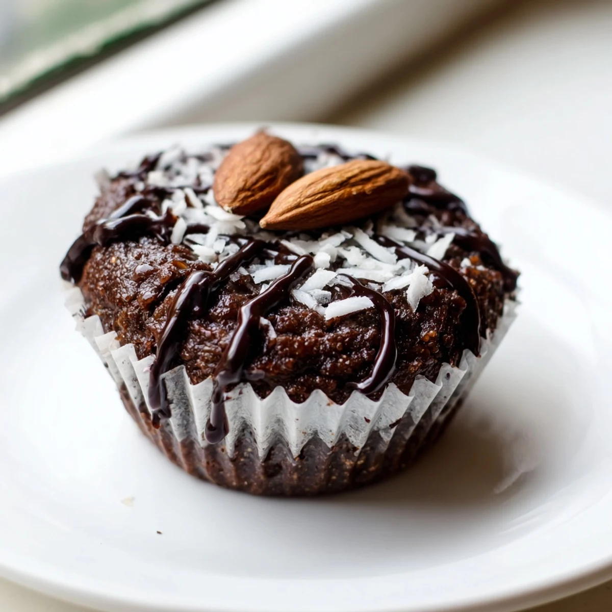 Moist gluten-free flourless almond joy cupcakes with a sweet coconut center on a wire rack