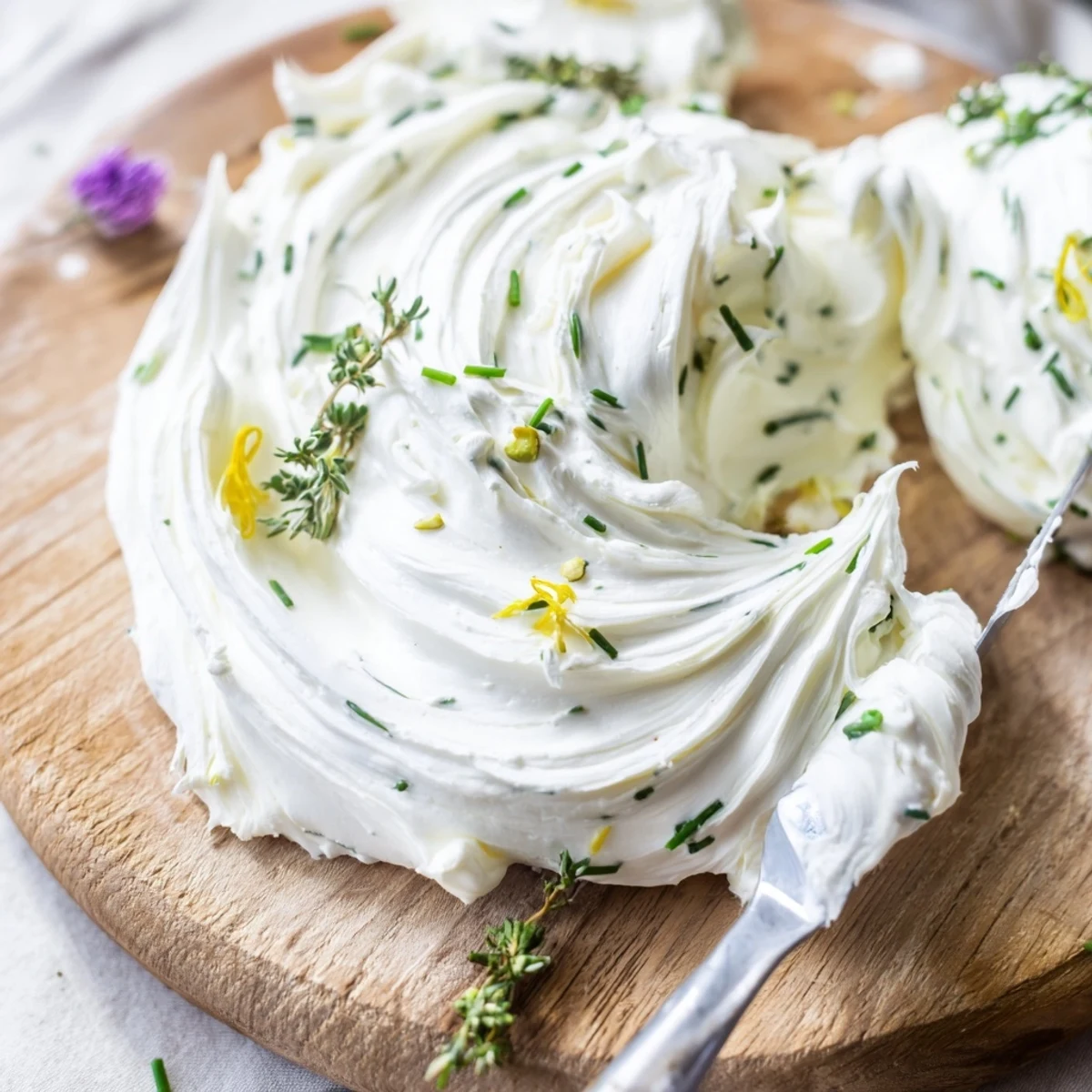Sliced Rustic Creamy Herb Infused Butter Board topped with edible flowers, nuts