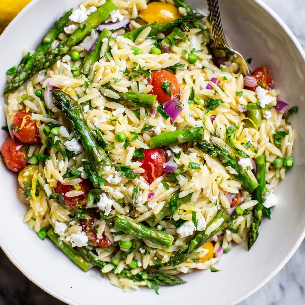 Asparagus Orzo Salad With Lemon Vinaigrette tossed with feta, parsley, and zesty dressing