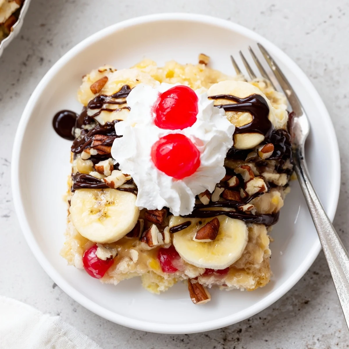 Banana Split Dump Cake bubbling golden, sliced bananas and chocolate chips visible