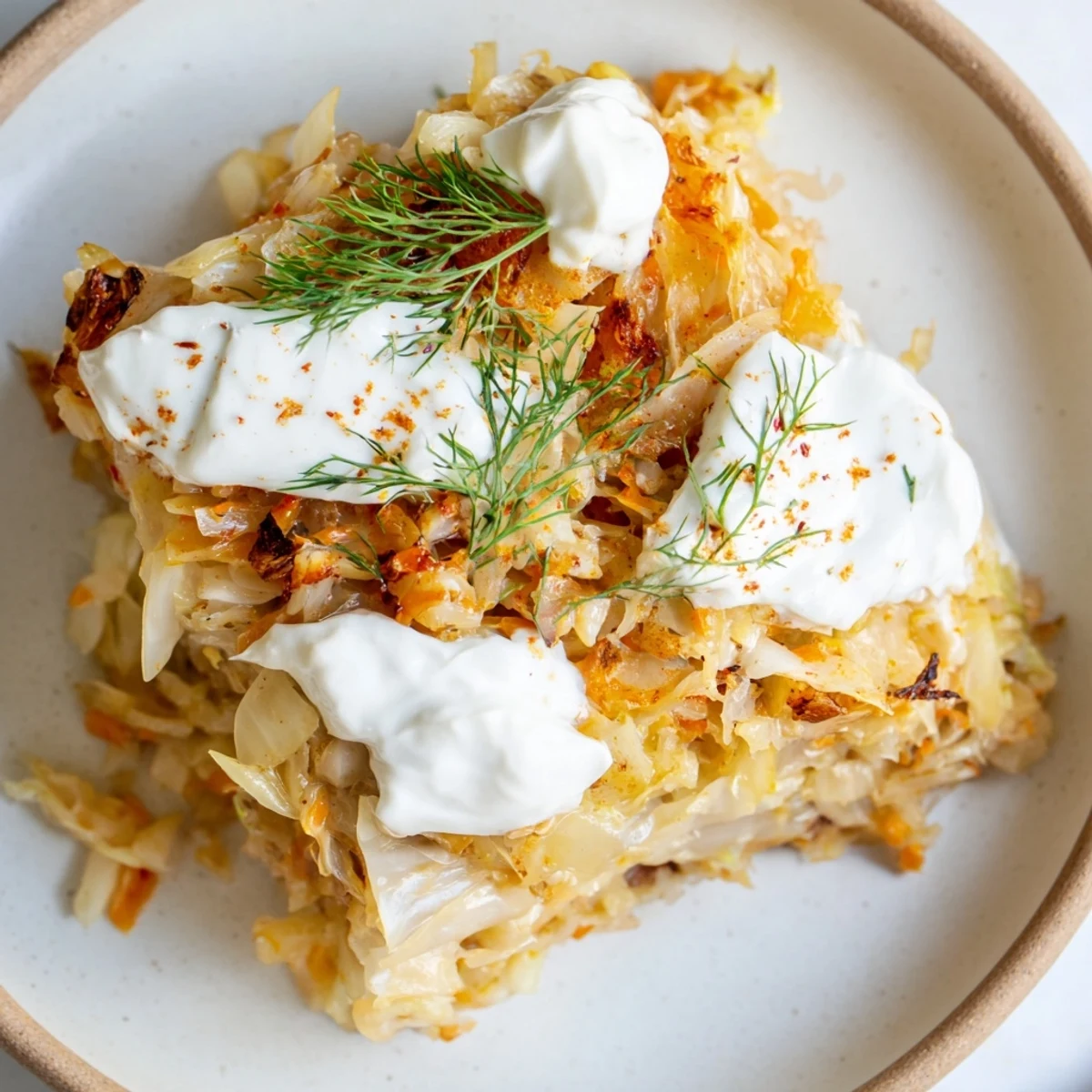 Comforting slow roasted cabbage and sauerkraut casserole served in a rustic white ceramic bowl