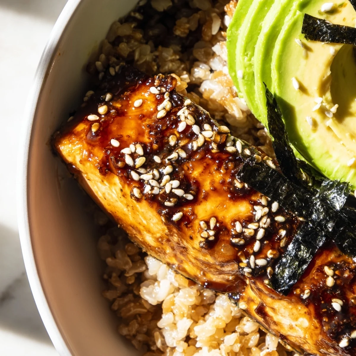 Tender miso salmon grain bowl topped with colorful fresh vegetables and sesame seeds
