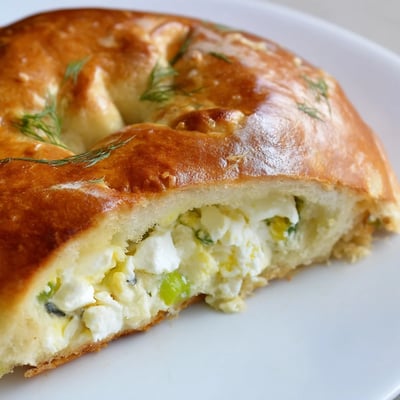 These soft baked Cheesy Egg and Cheese Piroshki are served warm with a side of sour cream.