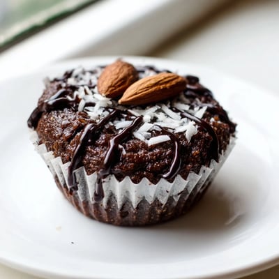 Moist gluten-free flourless almond joy cupcakes with a sweet coconut center on a wire rack