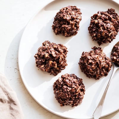 Thick Chocolate Oatmeal No Bake Cookies with chewy oat texture cooling on a sheet.